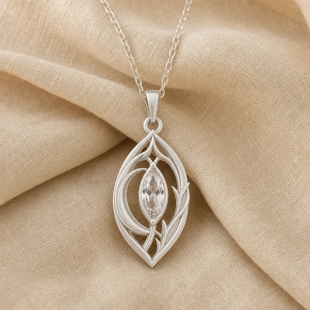 Moonlight crystal elven pendant with a clear marquise-cut crystal in a pointed setting, surrounded by flowing leaf-like openwork and an elegant teardrop-shaped frame. Silver finish.