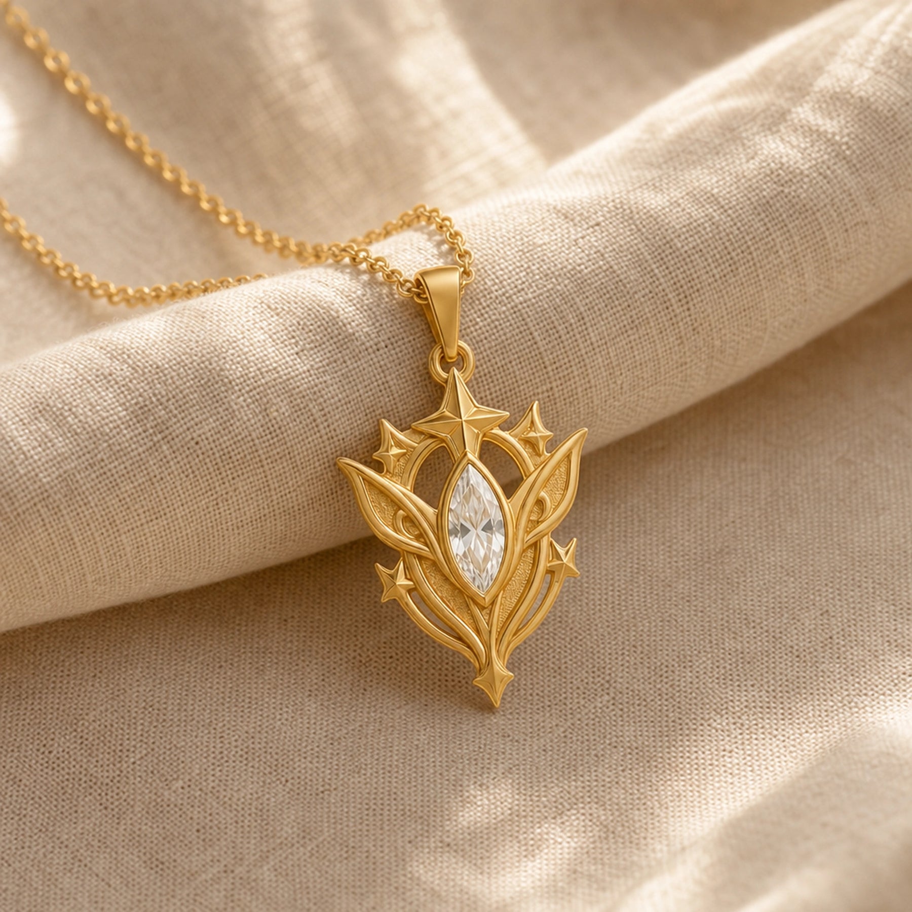 White Crystal Star Elf pendant in 925 sterling silver, featuring a faceted marquise clear crystal framed by pointed leaf forms, raised stars, and detailed celestial metalwork. Gold finish.