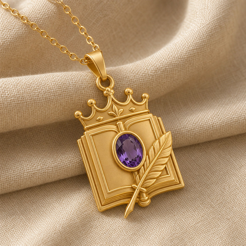Crowned quill codex amethyst pendant with an oval faceted purple stone in a raised setting, detailed book frame, sculpted feather, and ornate crown motif. Gold finish.