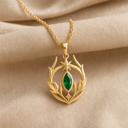 Emerald Elven Moonleaf pendant in 925 sterling silver, featuring a faceted marquise green stone set within an open crescent of sculpted leaves and a small star detail. Gold finish.