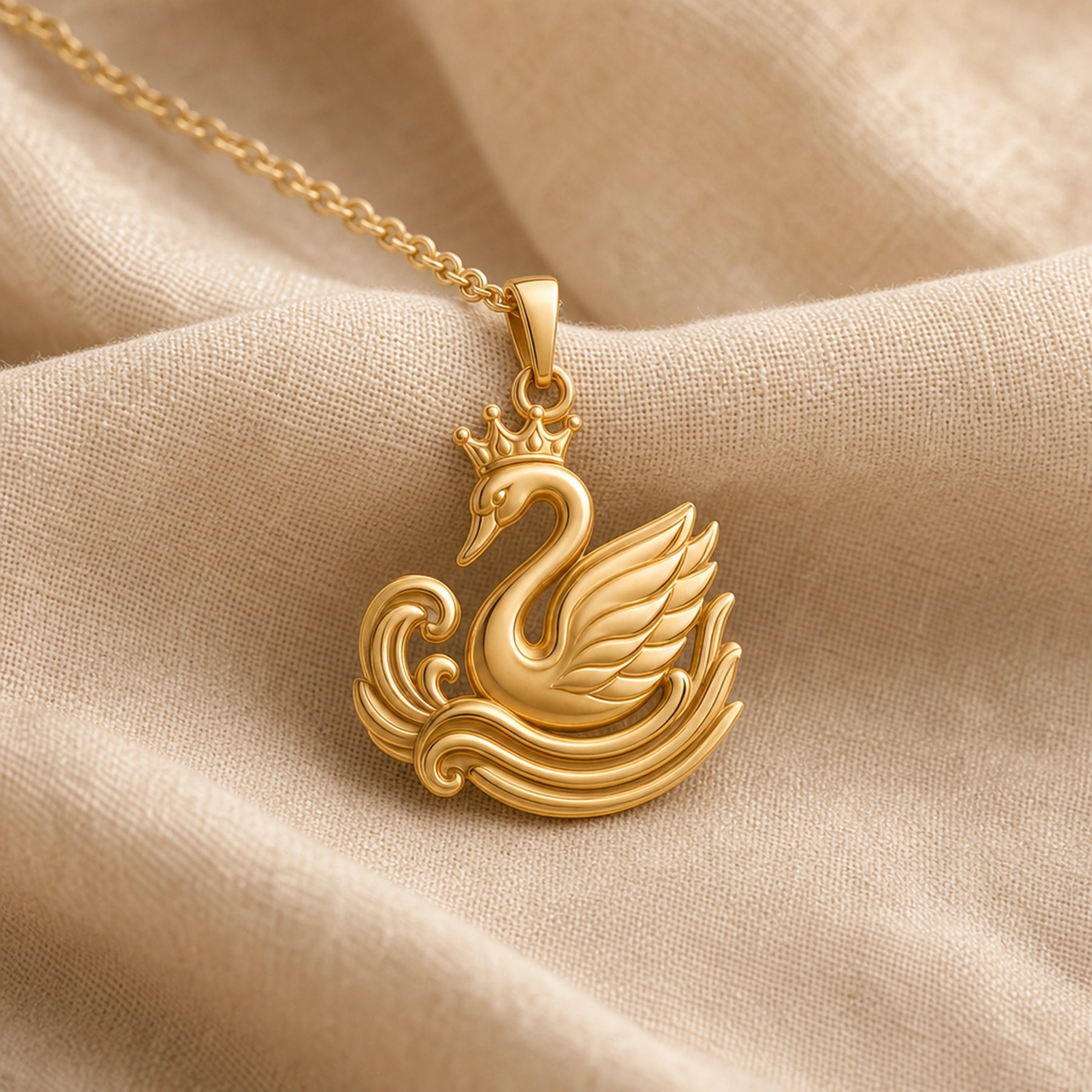 Crowned swan ripple pendant in a warm yellow finish, featuring a raised crown, curved swan neck, layered feather wing, and sculpted wave relief with no gemstone or stone setting. Gold finish.