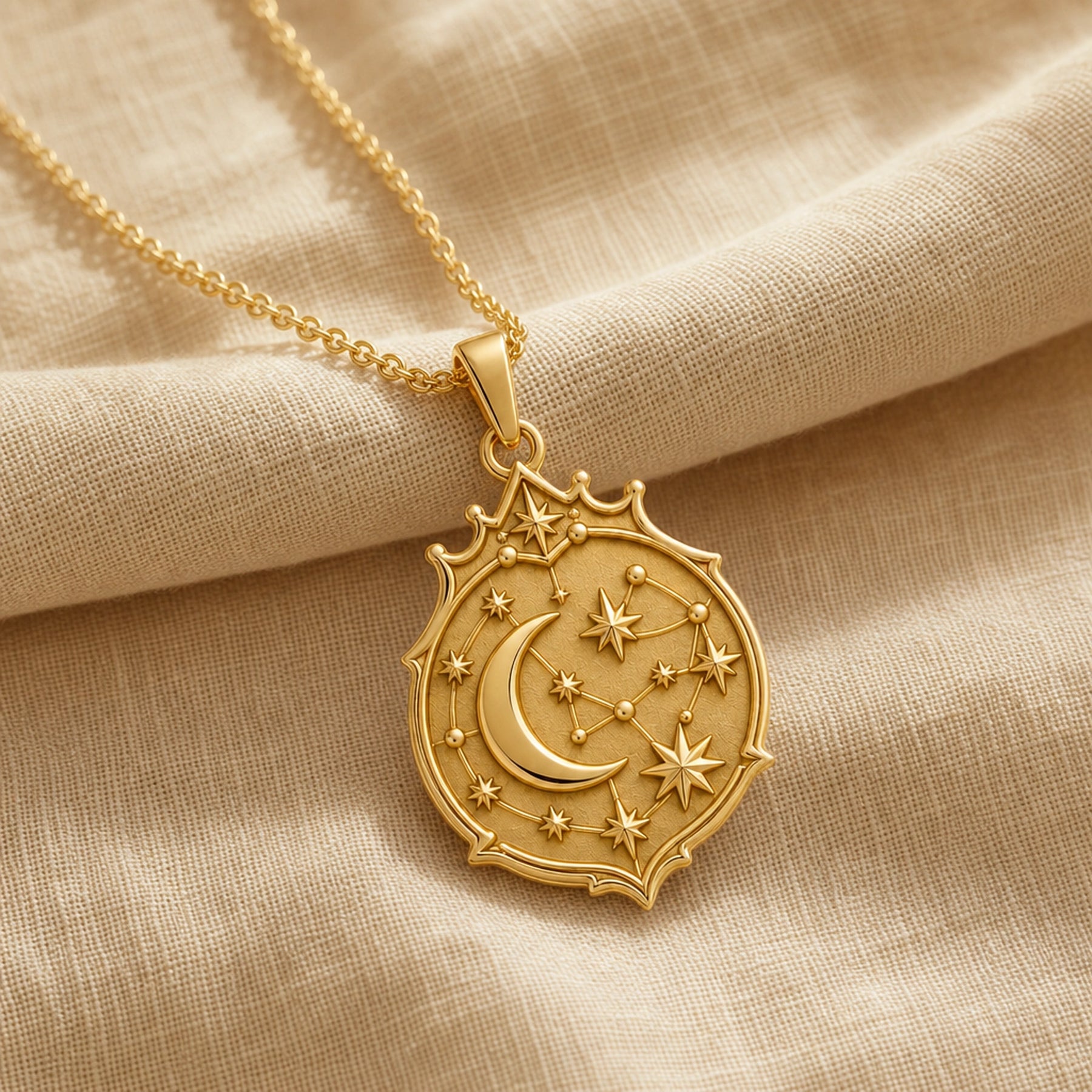Crescent constellation pendant with raised moon, sculpted stars, orbit-like lines and an ornate celestial medallion border in 925 sterling silver. Gold finish.