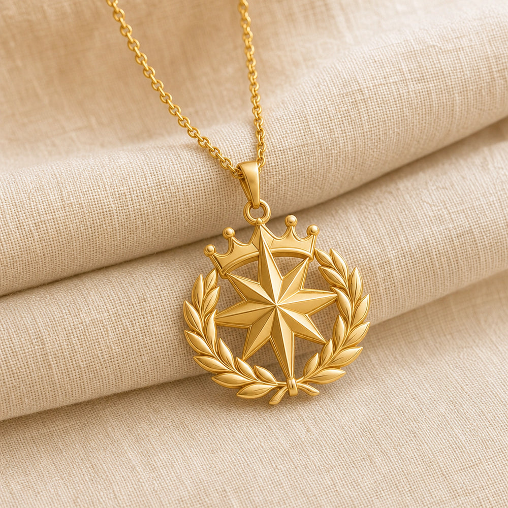 North Star laurel crown pendant with a raised faceted eight-point star, sculpted laurel leaf wreath, and detailed crown motif on a cable chain. Gold finish.