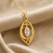 Moonlight crystal elven pendant with a clear marquise-cut crystal in a pointed setting, surrounded by flowing leaf-like openwork and an elegant teardrop-shaped frame. Gold finish.