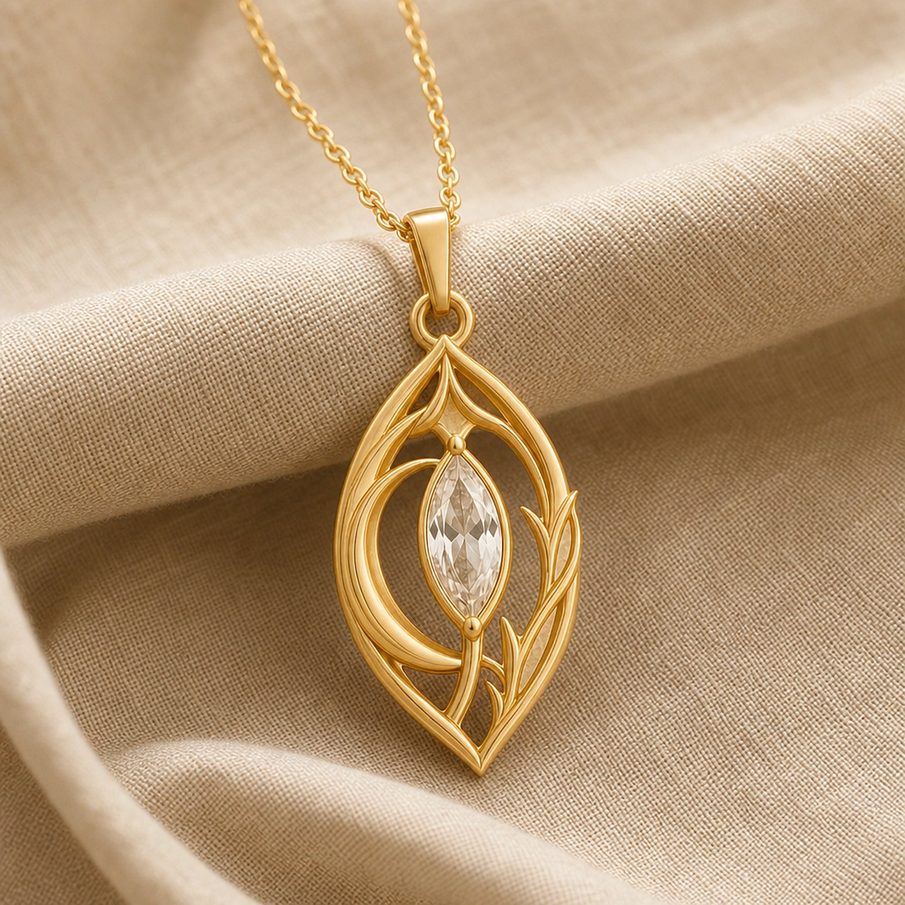 Moonlight crystal elven pendant with a clear marquise-cut crystal in a pointed setting, surrounded by flowing leaf-like openwork and an elegant teardrop-shaped frame. Gold finish.