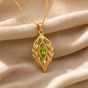 Blue Topaz Laurel Pendant with a green-toned faceted marquise stone, framed by detailed openwork laurel leaves in an elongated elven-inspired 925 sterling silver design. Gold finish.