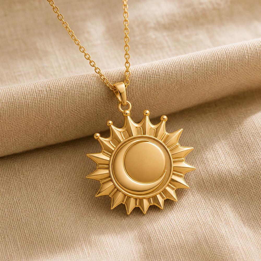 Regal eclipse sunray crown pendant with a raised circular center, pointed radiant rays, crown-like arches, and polished warm yellow finish on a cable chain. Gold finish.