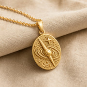 925 sterling silver oval quasar relief pendant with orbital rings, textured celestial details and a raised star. Gold finish.