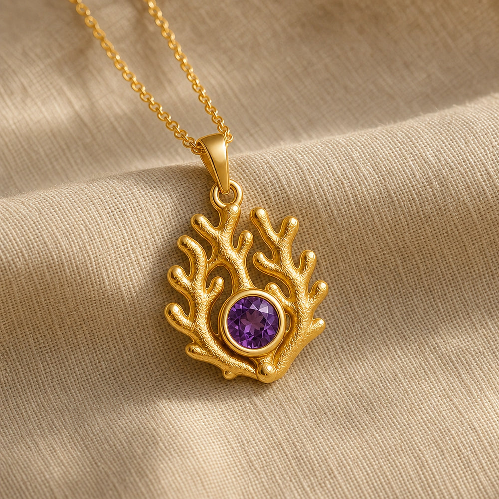 925 sterling silver branching coral pendant embracing a round purple amethyst birthstone centerpiece. Gold finish.
