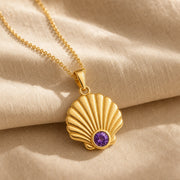 925 sterling silver fan-shaped seashell pendant with fluted relief and a round purple amethyst birthstone. Gold finish.