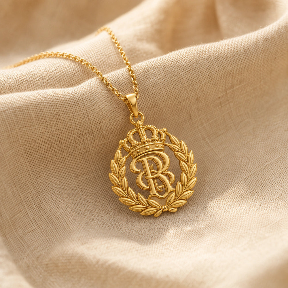 Handcrafted 925 sterling silver sovereign laurel crown monogram pendant shown as a detailed pendant necklace. Gold finish.