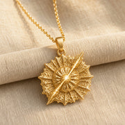 925 sterling silver round supernova quasar pendant with radiating relief and a highly textured celestial surface. Gold finish.