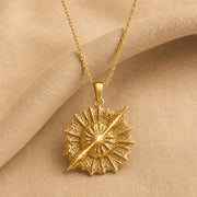 925 sterling silver round supernova quasar pendant with radiating relief and a highly textured celestial surface. Gold finish.