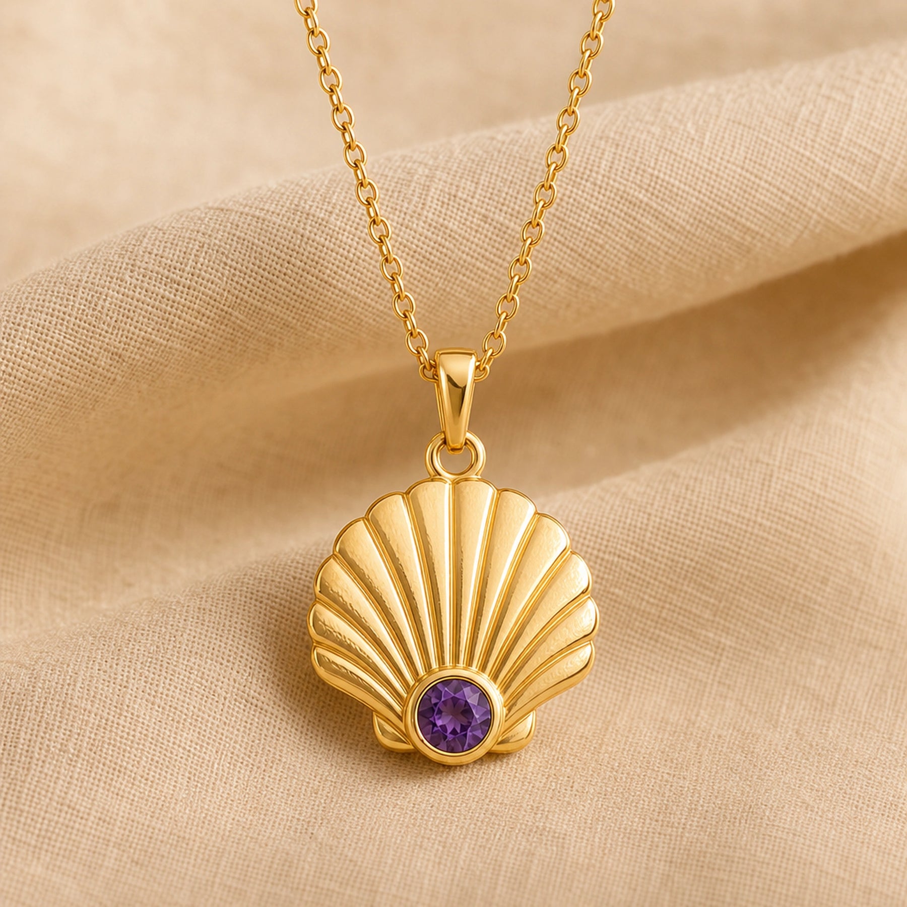 925 sterling silver fan-shaped seashell pendant with fluted relief and a round purple amethyst birthstone. Gold finish.