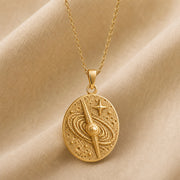 925 sterling silver oval quasar relief pendant with orbital rings, textured celestial details and a raised star. Gold finish.