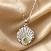 925 sterling silver Pearl Shell pendant with raised fan-shaped fluting and a round green peridot centerpiece. Silver finish.