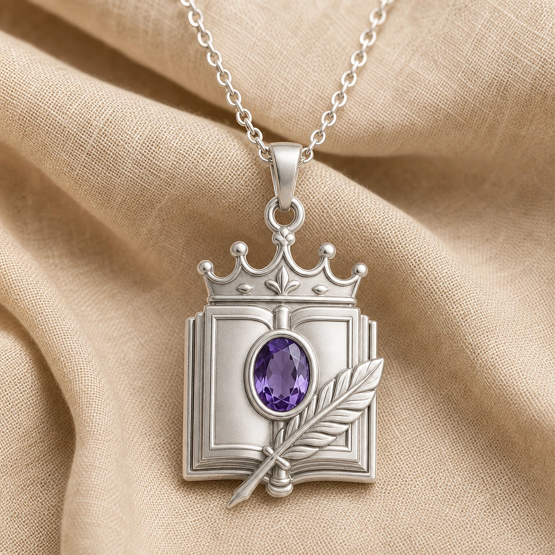 Crowned quill codex amethyst pendant with an oval faceted purple stone in a raised setting, detailed book frame, sculpted feather, and ornate crown motif. Silver finish.