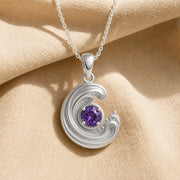 925 sterling silver wavecrest pendant curling around a round purple amethyst centerpiece with flowing textured details. Silver finish.