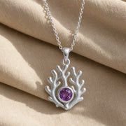 925 sterling silver branching coral pendant embracing a round purple amethyst birthstone centerpiece. Silver finish.