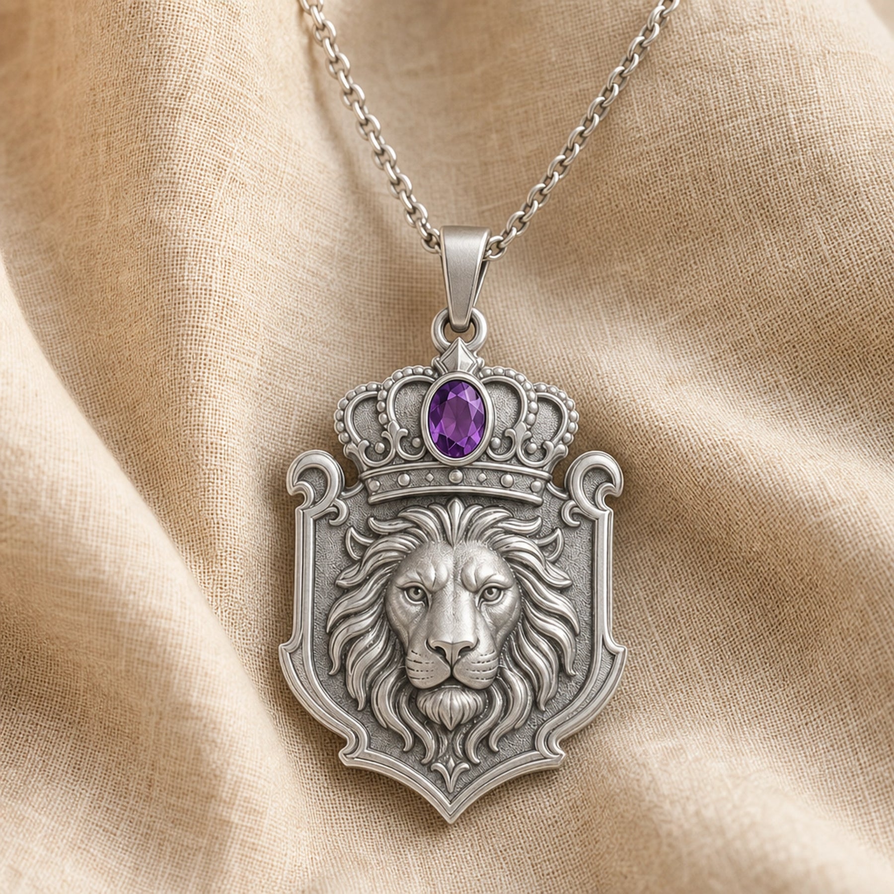 Amethyst crown lion crest pendant with a detailed lion head in a shield-shaped relief, ornate crown scrollwork, and an oval purple amethyst stone in a framed setting. Silver finish.