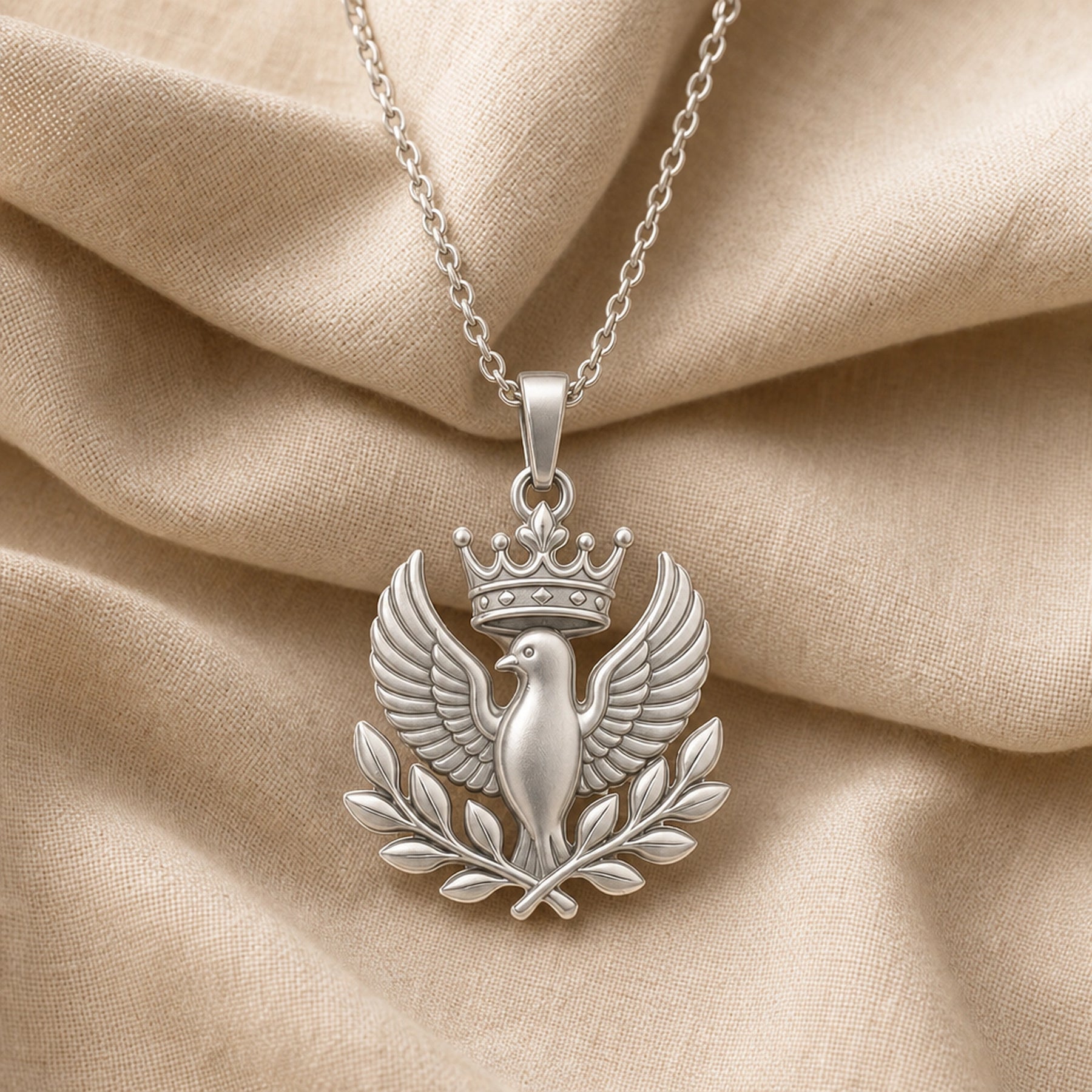 Regal olive dove crown pendant in 925 sterling silver, showing a raised dove with spread feathered wings, a detailed crown above, and crossed olive branches below without a gemstone setting. Silver finish.