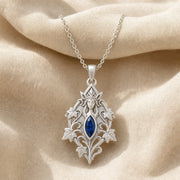 Sapphire ivy elven princess pendant with a deep blue marquise-shaped stone in a framed setting, surrounded by raised ivy leaves, curling vines, and detailed fantasy relief. Silver finish.