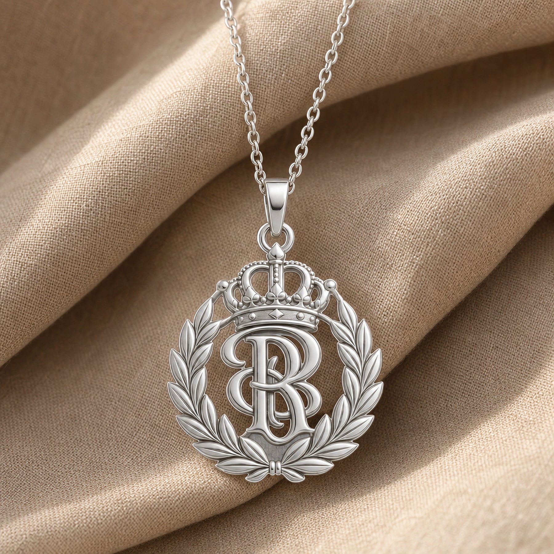 Handcrafted 925 sterling silver sovereign laurel crown monogram pendant shown as a detailed pendant necklace. Silver finish.