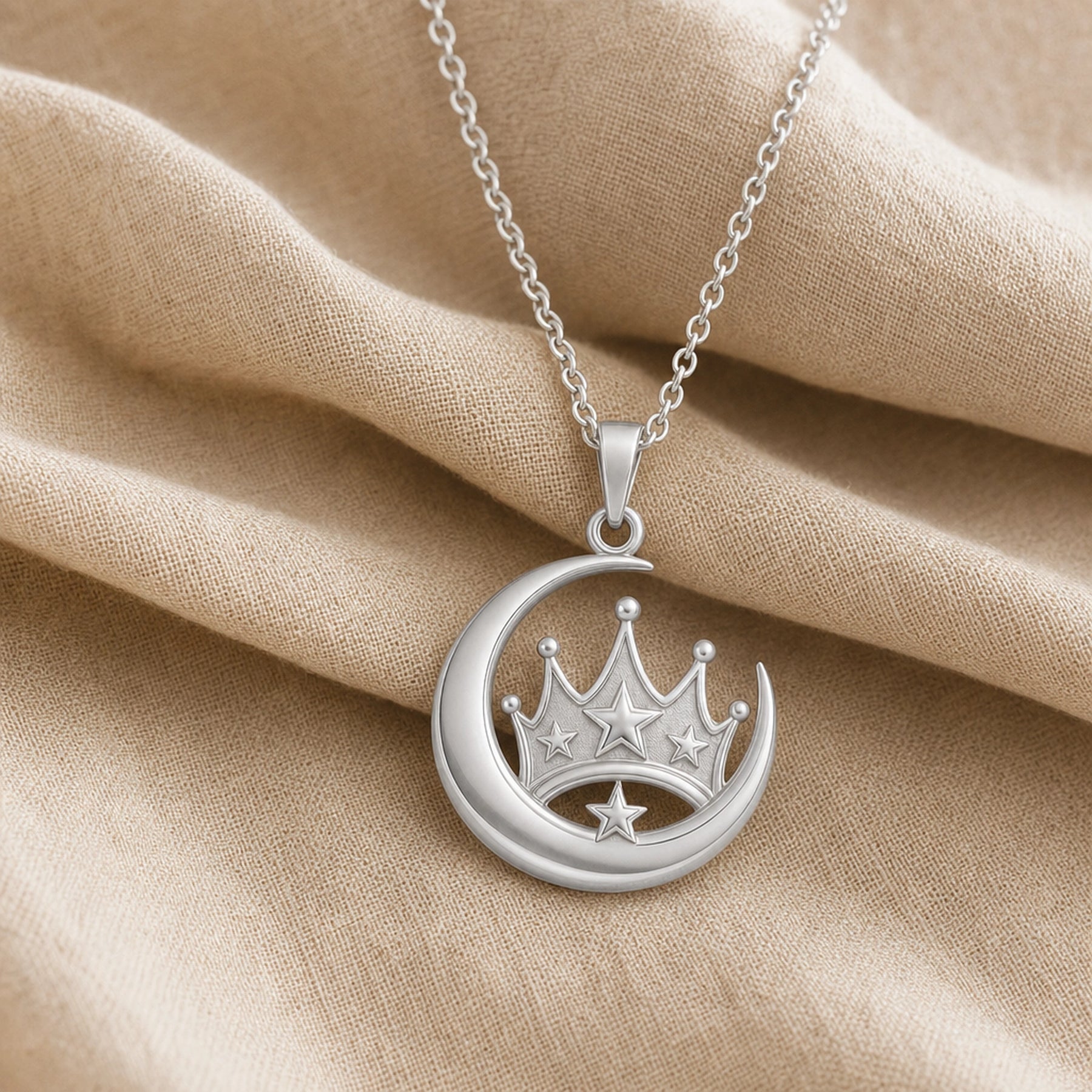 Royal moonstar crown pendant in 925 sterling silver with a polished crescent moon surrounding a raised crown, dimensional star accents, and a detailed celestial design. Silver finish.