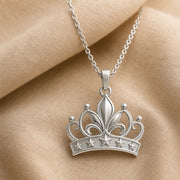 Lily star crown pendant with sculpted flower petals, openwork crown scrolls and raised star details, suspended from a cable chain in 925 sterling silver. Silver finish.