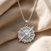 925 sterling silver round supernova quasar pendant with radiating relief and a highly textured celestial surface. Silver finish.