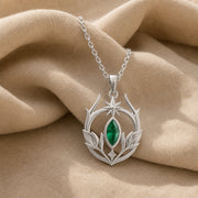 Emerald Elven Moonleaf pendant in 925 sterling silver, featuring a faceted marquise green stone set within an open crescent of sculpted leaves and a small star detail. Silver finish.