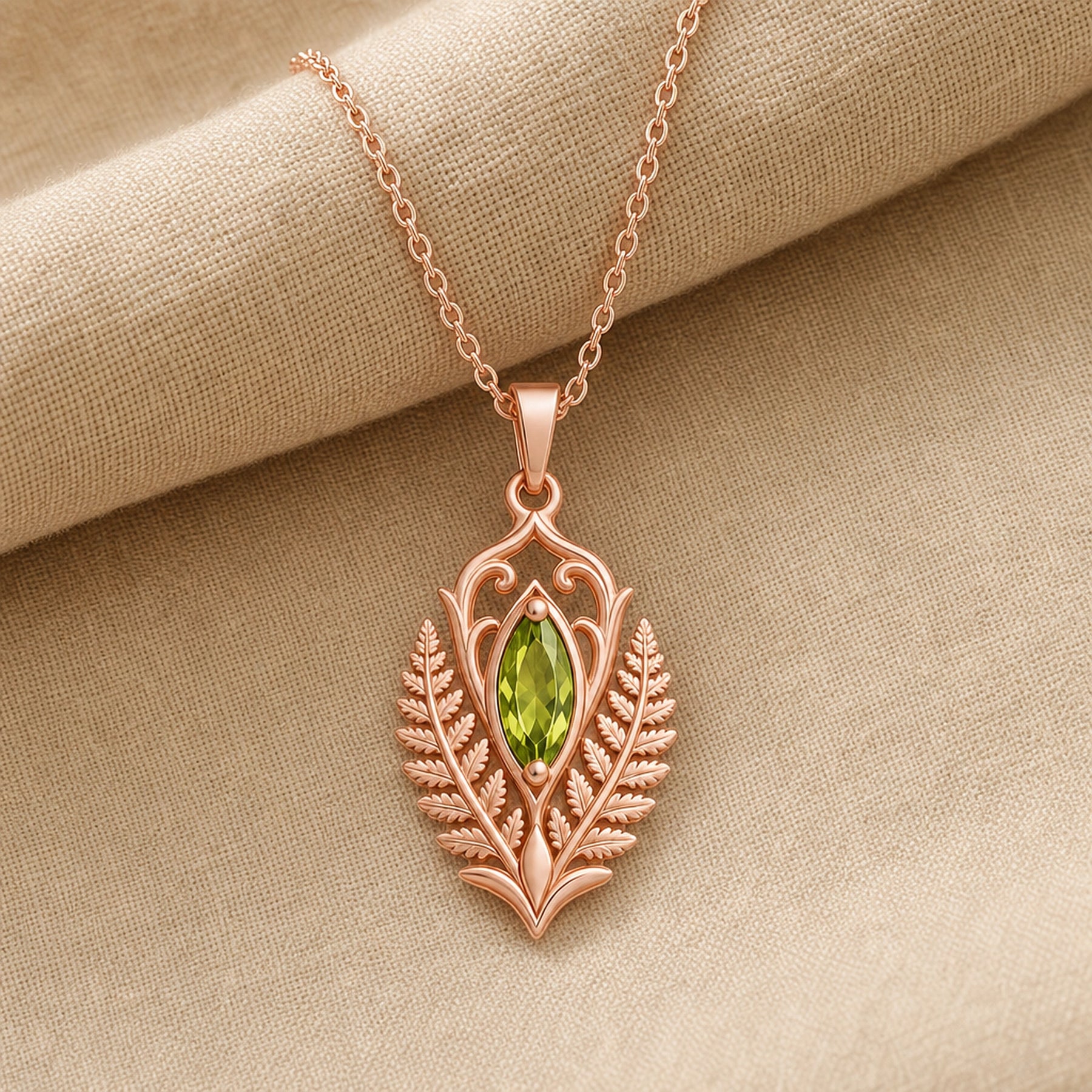 Marquise peridot fern pendant with a vivid green faceted stone in a smooth setting, framed by raised elven fern leaves, openwork scrolls, and botanical relief details. Rose gold finish.