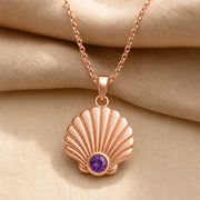 925 sterling silver fan-shaped seashell pendant with fluted relief and a round purple amethyst birthstone. Rose gold finish.