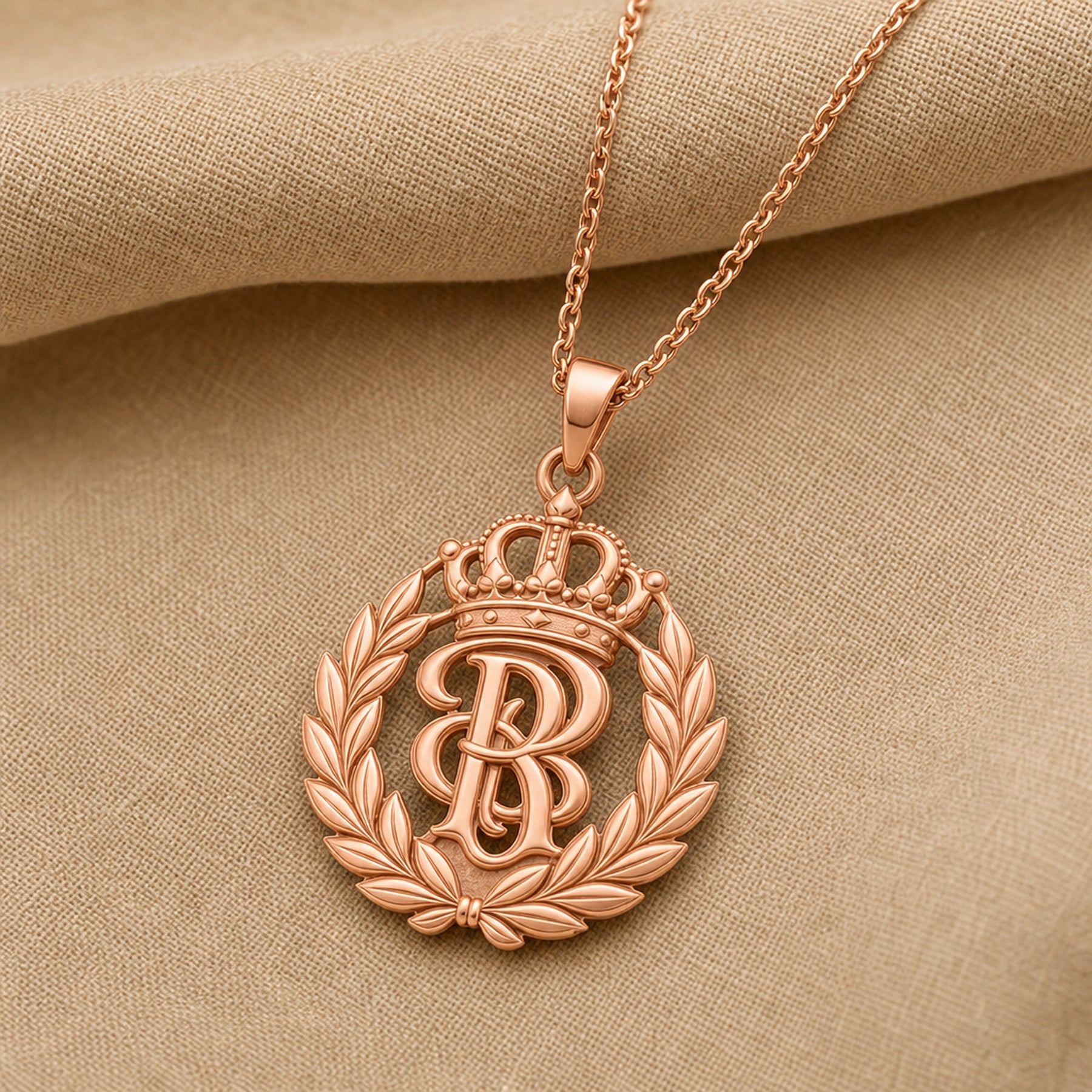 Handcrafted 925 sterling silver sovereign laurel crown monogram pendant shown as a detailed pendant necklace. Rose gold finish.