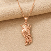 Star-crowned comet pendant with a raised central star, smaller stars along layered sweeping comet trails, and a detailed beaded crown in a warm yellow-toned finish. Rose gold finish.