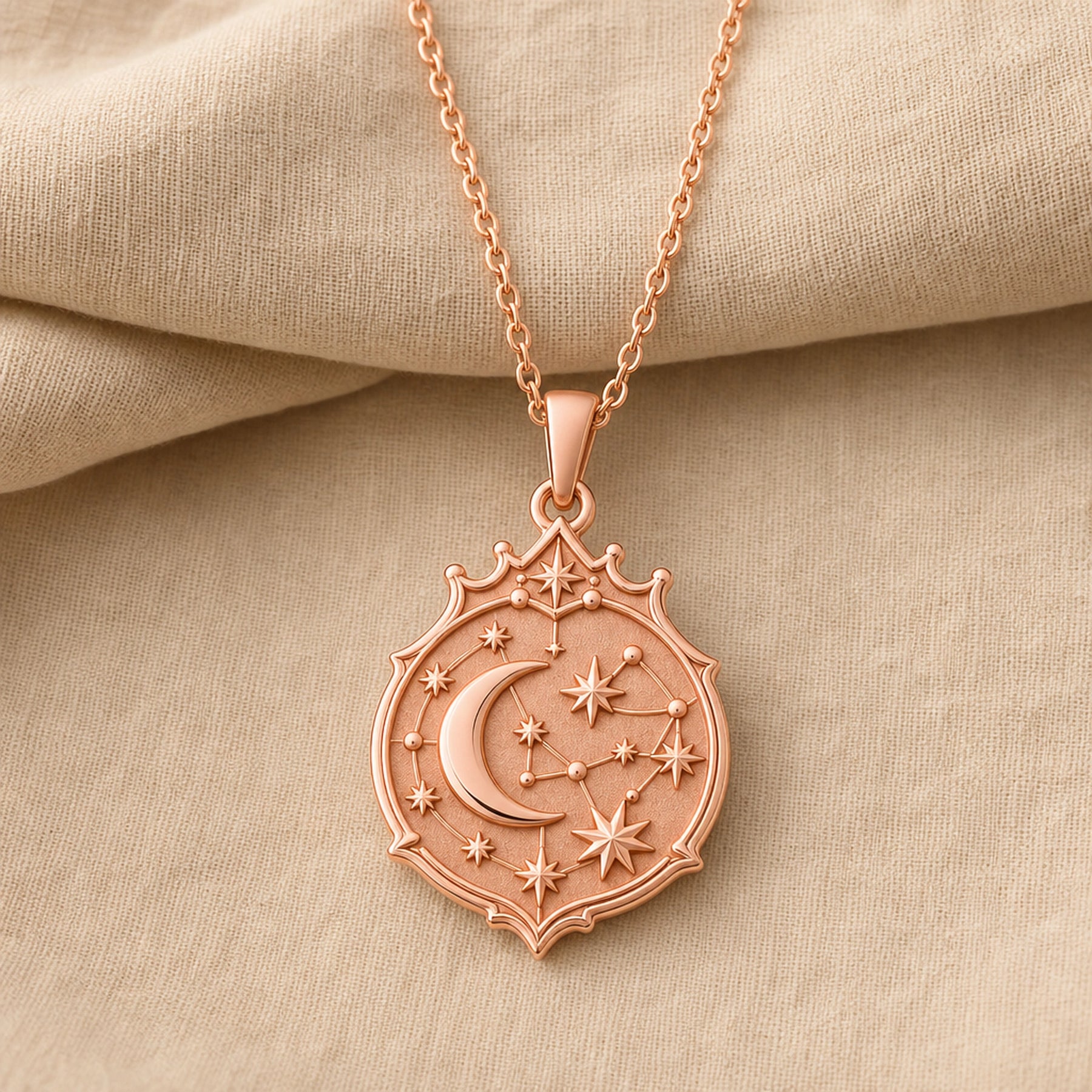 Crescent constellation pendant with raised moon, sculpted stars, orbit-like lines and an ornate celestial medallion border in 925 sterling silver. Rose gold finish.