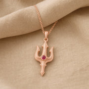 Ruby trident pendant necklace in 925 sterling silver with curved three-pronged relief design and a round vivid red center stone in a bezel-style setting. Rose gold finish.