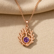 925 sterling silver branching coral pendant embracing a round purple amethyst birthstone centerpiece. Rose gold finish.