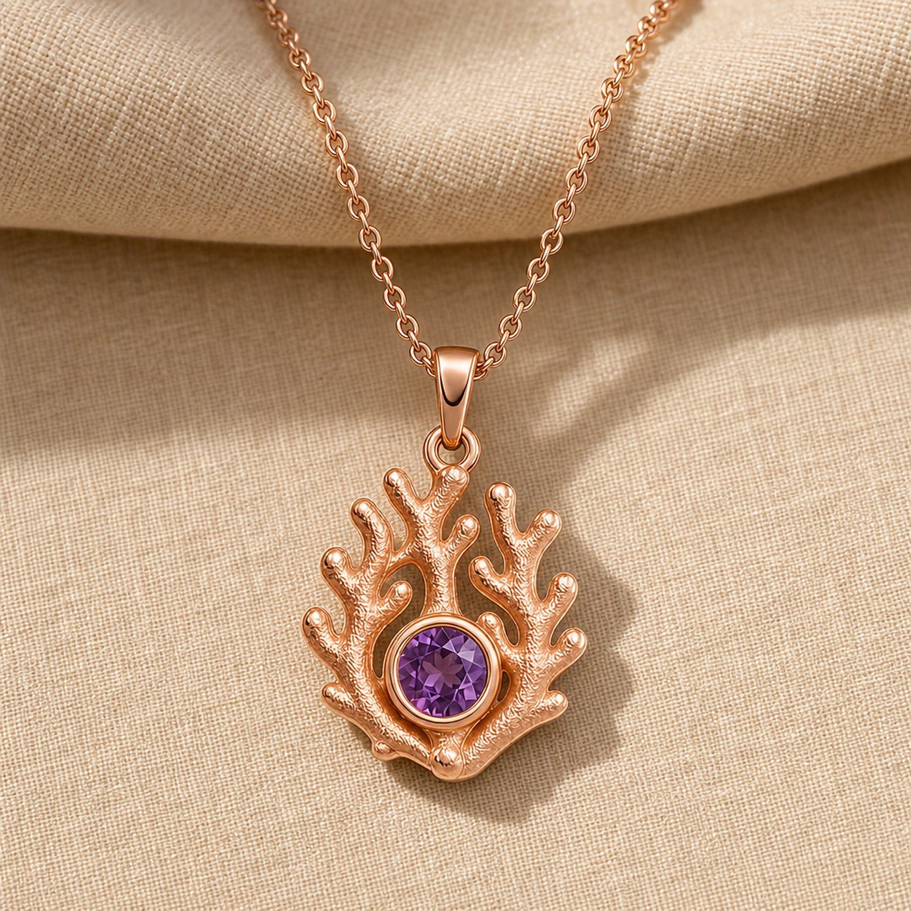 925 sterling silver branching coral pendant embracing a round purple amethyst birthstone centerpiece. Rose gold finish.