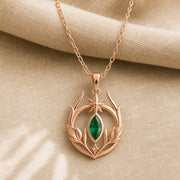Emerald Elven Moonleaf pendant in 925 sterling silver, featuring a faceted marquise green stone set within an open crescent of sculpted leaves and a small star detail. Rose gold finish.