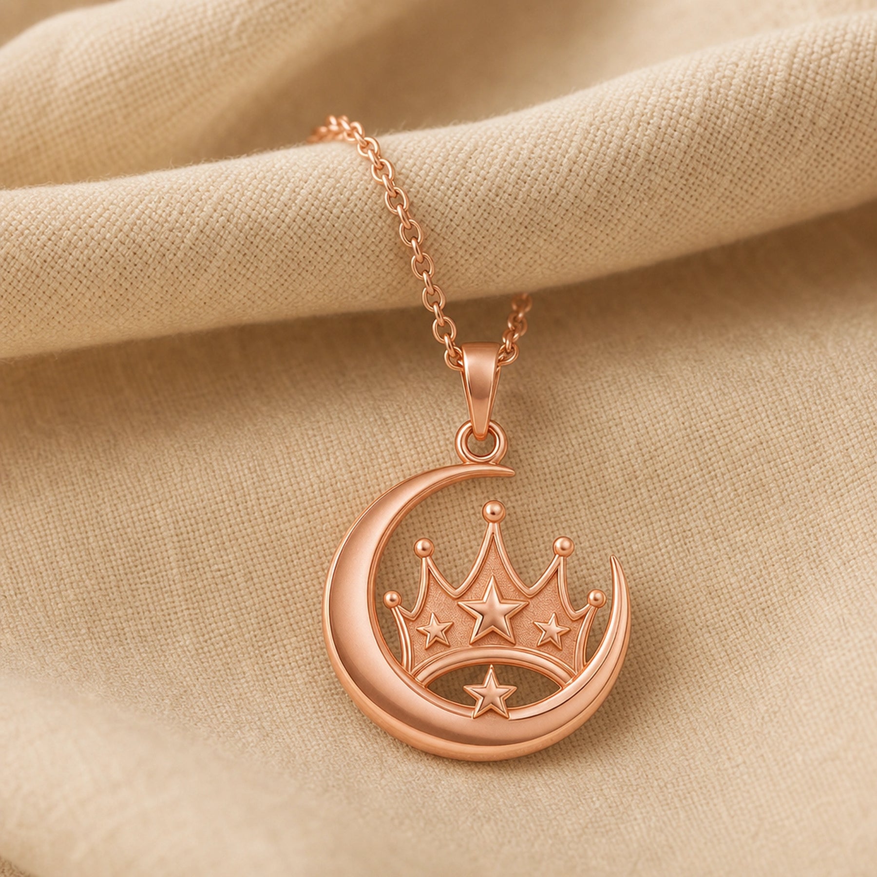 Royal moonstar crown pendant in 925 sterling silver with a polished crescent moon surrounding a raised crown, dimensional star accents, and a detailed celestial design. Rose gold finish.
