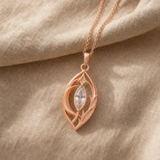 Moonlight crystal elven pendant with a clear marquise-cut crystal in a pointed setting, surrounded by flowing leaf-like openwork and an elegant teardrop-shaped frame. Rose gold finish.