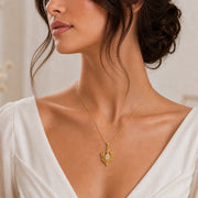White Crystal Star Elf pendant in 925 sterling silver, featuring a faceted marquise clear crystal framed by pointed leaf forms, raised stars, and detailed celestial metalwork. Worn on a model, front view.