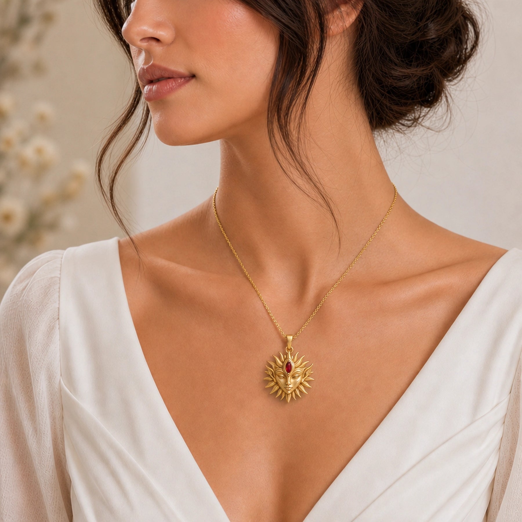 Marquise ruby sun elf pendant with a detailed sculpted elf face, radiating sun rays, and a deep red marquise stone set at the center of the forehead. Worn on a model, front view.