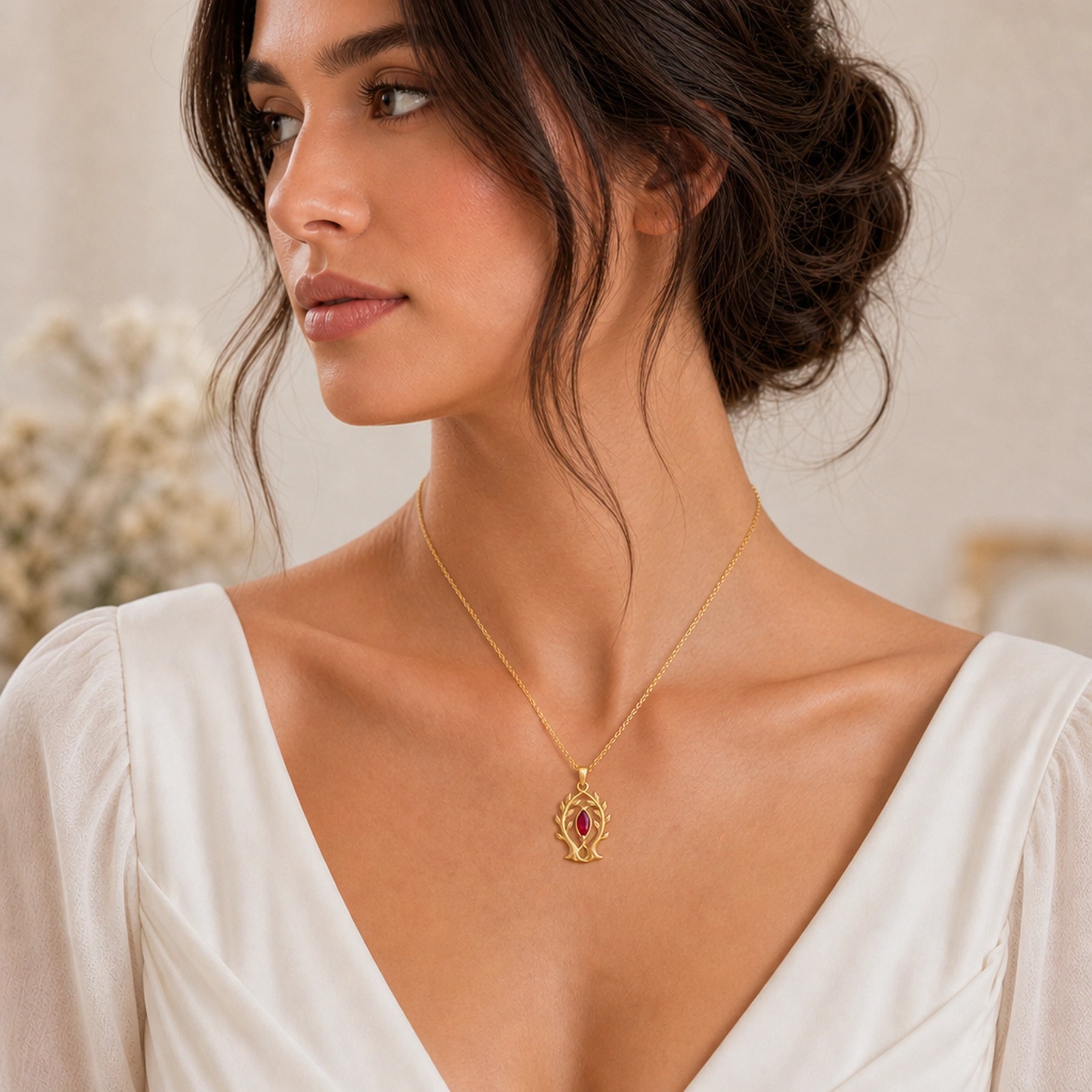 Marquise ruby branch pendant in 925 sterling silver, featuring a deep red faceted marquise stone held in a leaf-tipped openwork tree frame. Worn on a model, angled view.