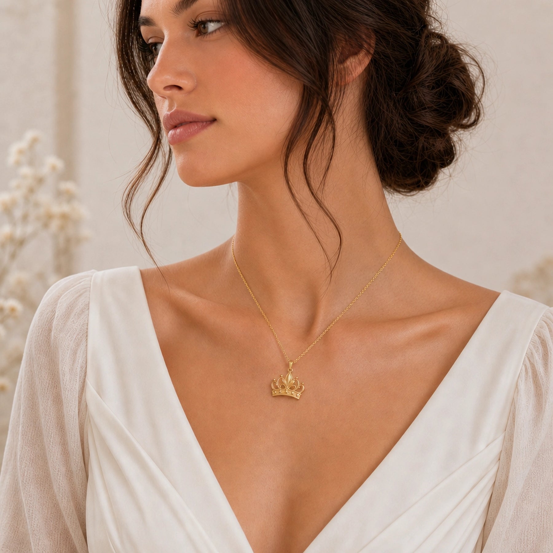 Lily star crown pendant with sculpted flower petals, openwork crown scrolls and raised star details, suspended from a cable chain in 925 sterling silver. Worn on a model, angled view.
