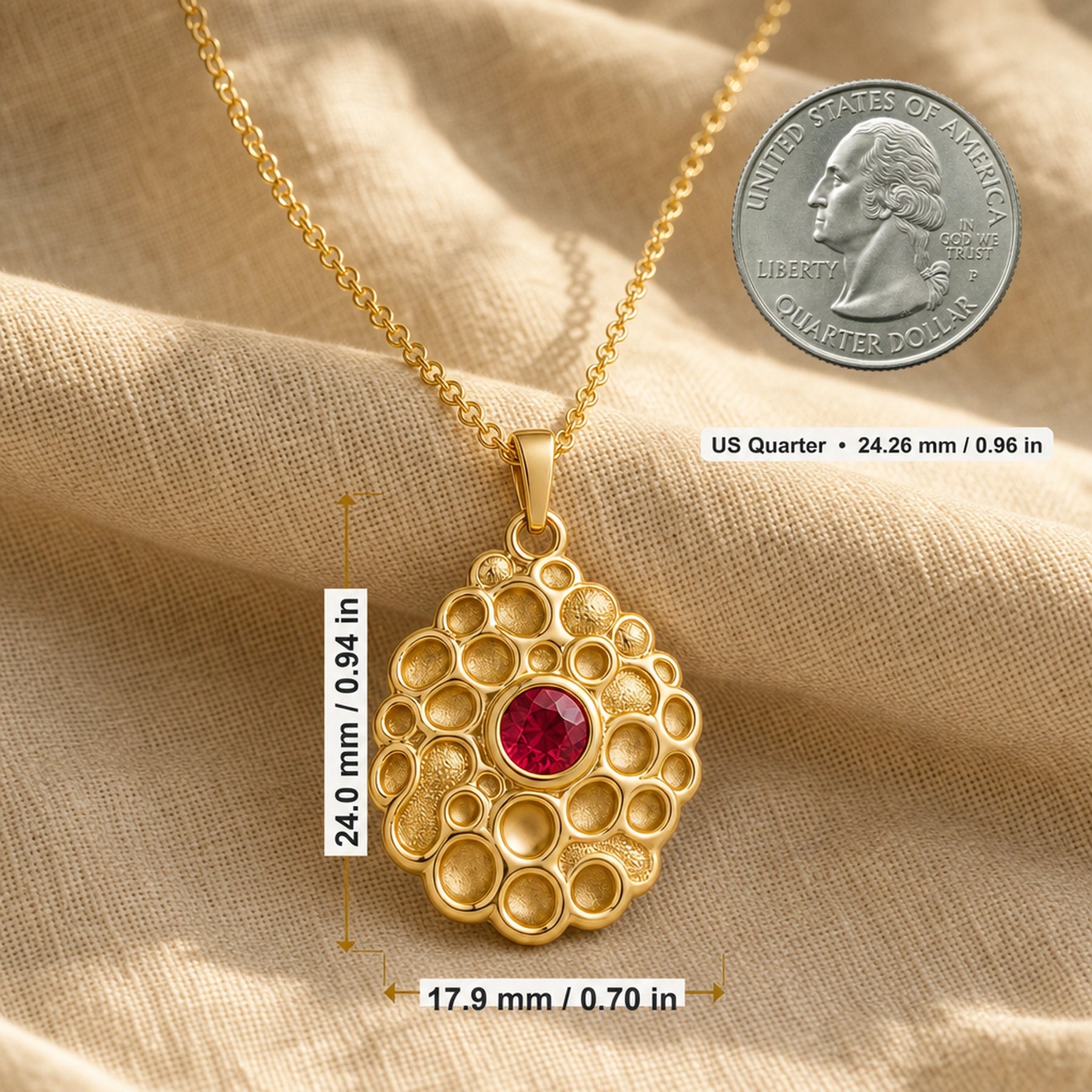 Ruby seafoam pendant with a round deep-red stone in a smooth bezel setting, surrounded by raised textured circular cells in an organic seafoam design on a cable chain. Product dimensions and measurements.